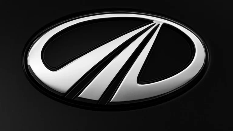 The elegant mahindra car logo on a glossy black surface, hinting at the new edition.