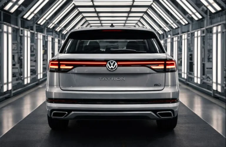 Rear view of the made-in-India VW Tayron, showcasing the connected LED tail lamps and illuminated logo in the factory.