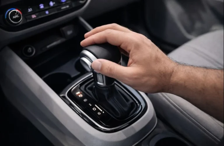 A sleek automatic gear lever in a modern city car, symbolizing ease of driving in traffic.